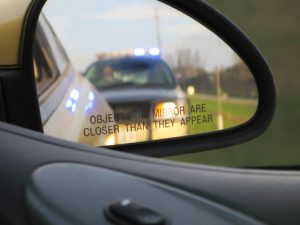 police car in rearview mirror